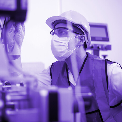 Technician wearing hard hat and face mask